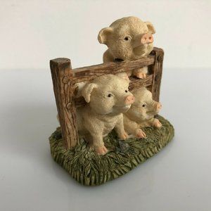 3 pigs and a fence.  Resin figurine. 2.5 inches tall Overall in great condition